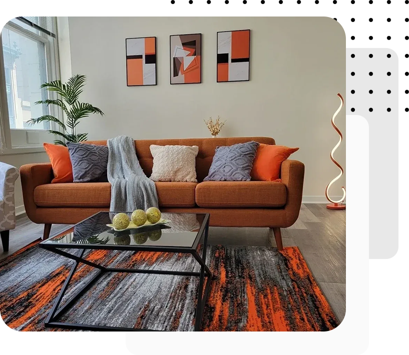 A living room with orange and grey decor.