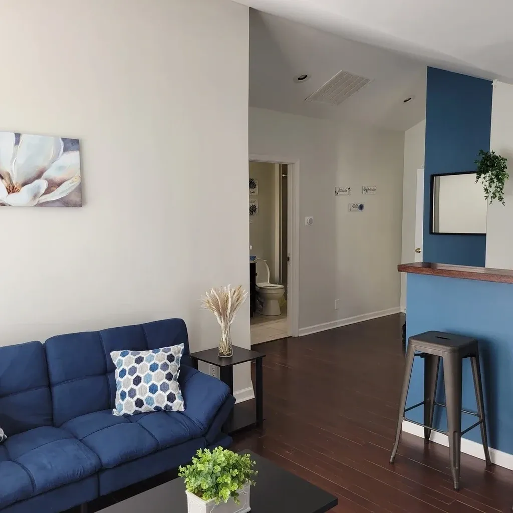 A living room with blue walls and furniture.