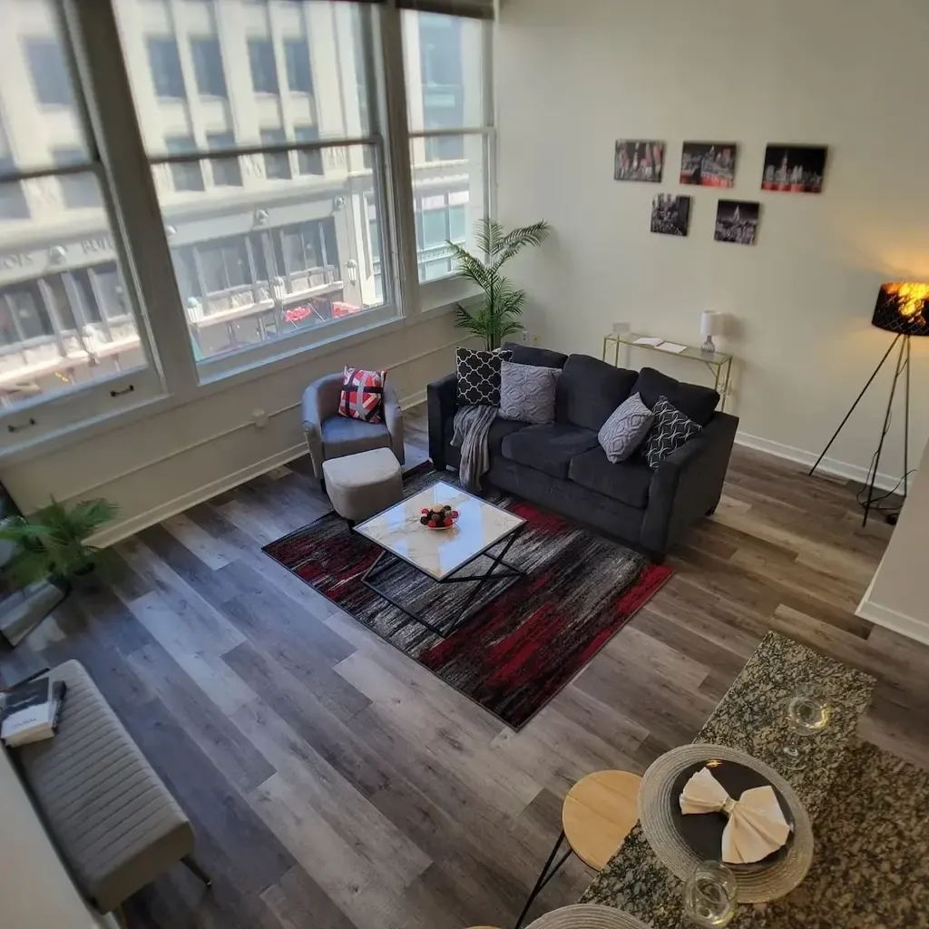 A living room with a couch, chair and table.