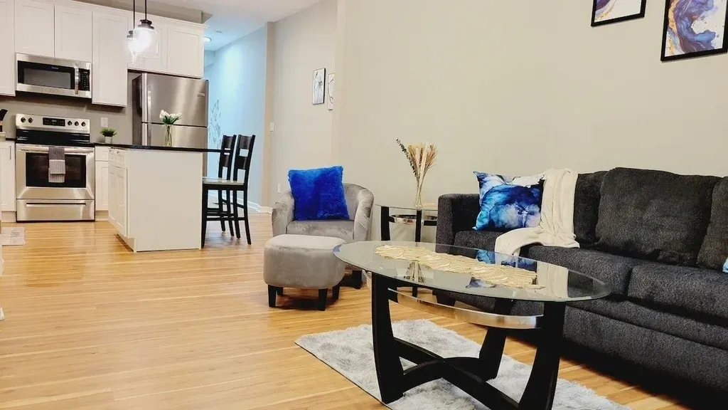 A living room with chairs, table and couch.